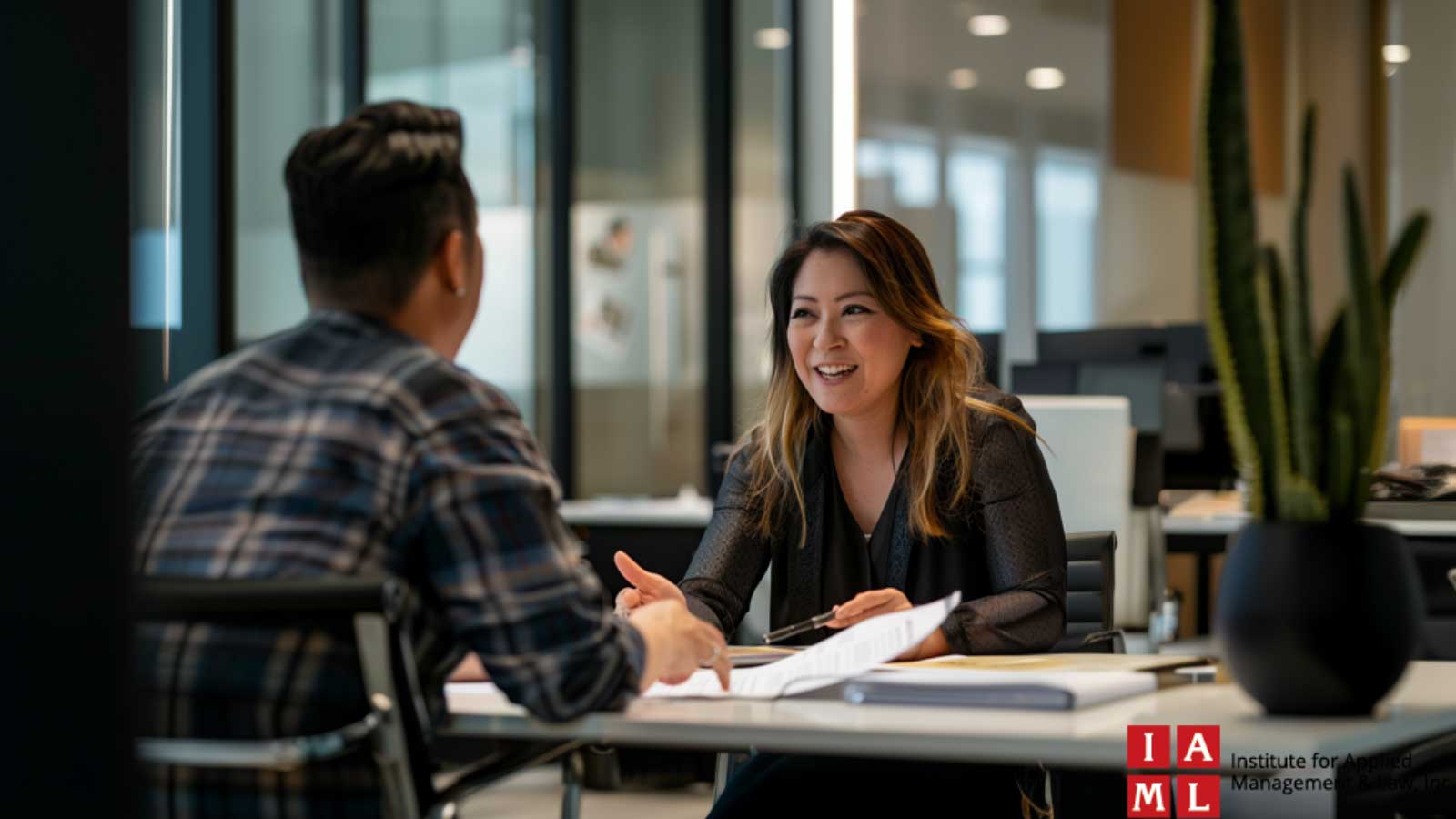 HR professionals discussing employee relations certifications at a modern office.