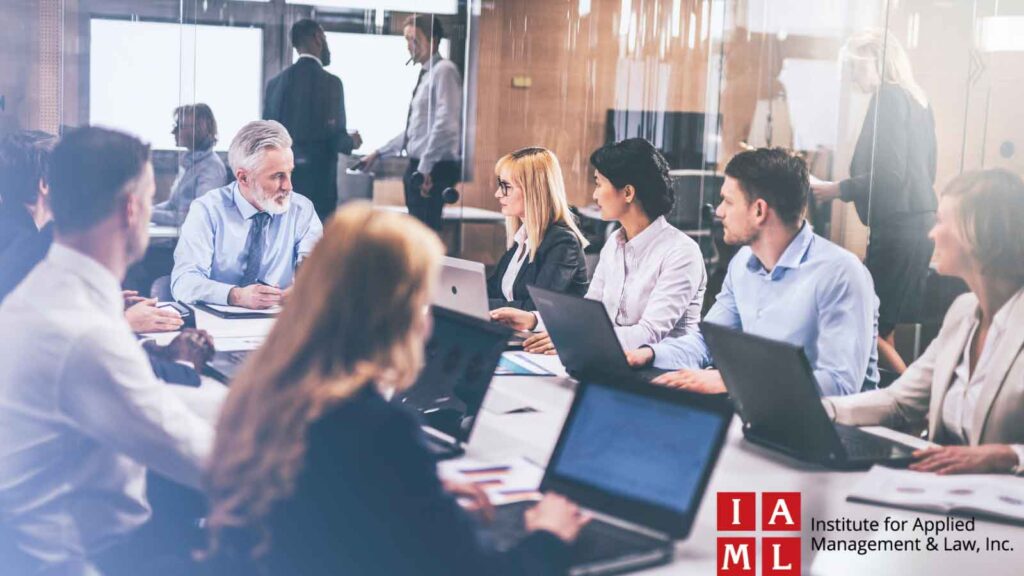 A large group of employees attending a seminar in a conference room.