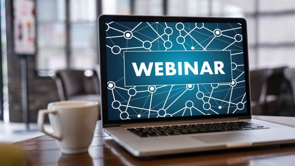 Close-up of a laptop screen displaying the word 'webinar'.